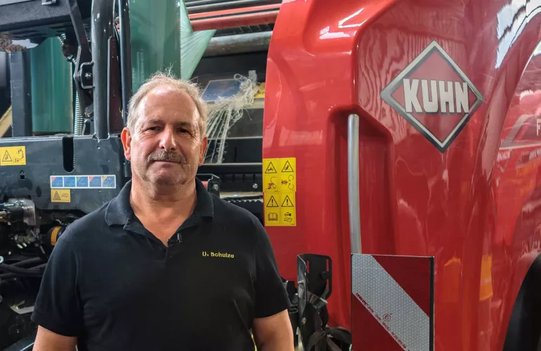 Photo of Uwe Schulze with baler-wrapper in background