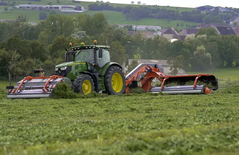 a tractor with a font merger and side merger in the field