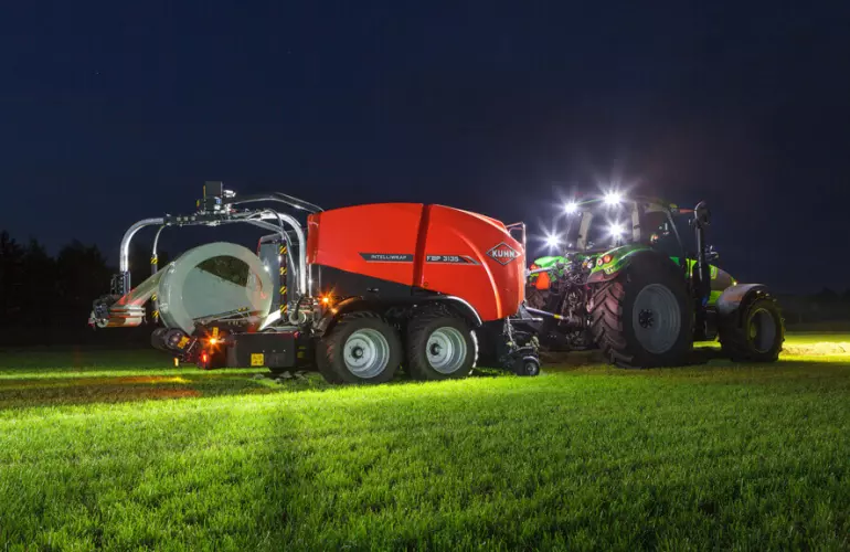 FBP 3135 3D wrapping a bale in the dark lightened with working lights