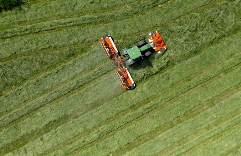 The mower conditioner with swath grouper FC 9330 RA at work in grassland