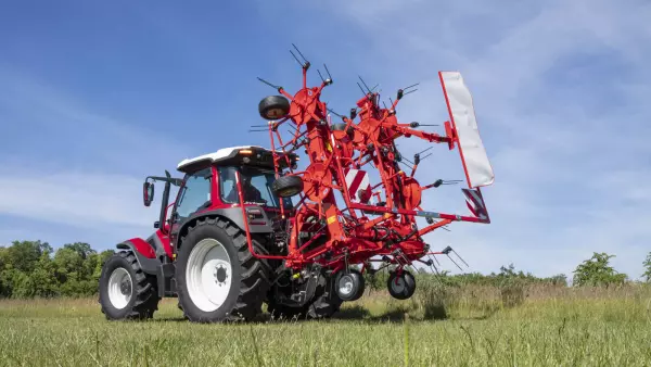 KUHN's GF 8700 tedder in transport position in a field