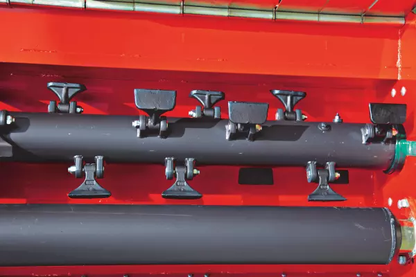 A roller positioned closest to the rotor for improved shredding and residue decomposition.