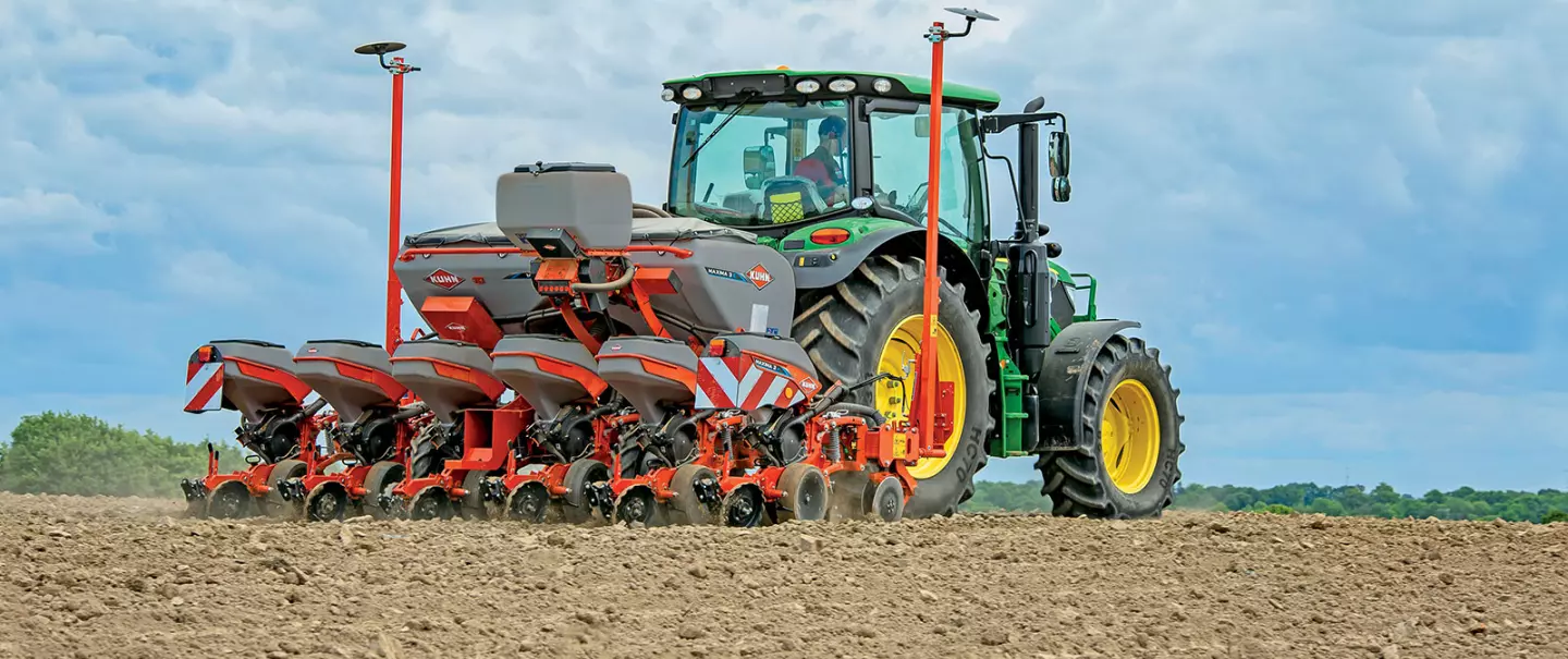 Image of Kuhn MAXIMA 3 precision seed drill at work hitched to a tractor