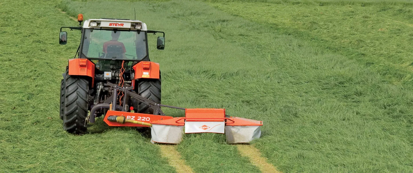 PZ 220 drum mower with conditioner is mowing gras on a flat field