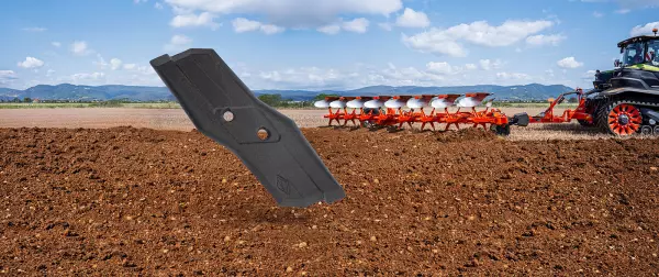 olimpic point with a plough machine working in the field