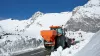 AXEO salt, sand, gravel and fertiliser spreader at work on a mountain road in the snow