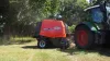 Kuhn FB 2130 baling in a corner of the field with trees at the background