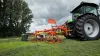 The HAYBOB 360 making a windrow under a cloudy sky.