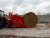 KUHN PRIMOR 2060 H loaded with a round bale