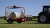 RW 1800 round bale wrapper wrapping bales in a field.
