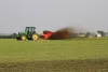 Side view of a SL 124 spreading liquid slurry in a field.