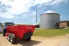 A SL 124 is up ahead pulling into a farm driveway.