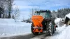 VSA salt and sand spreader at work on mountain roads in the snow